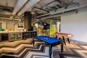 A modern indoor space with a pool table, seating area, and a bar. - Van der Valk Hotel Paris CDG Airport (Roissy-en-France)