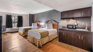 A hotel room with two beds, a kitchenette, and a large window. - OYO Hotel Orlando Airport (Orlando)