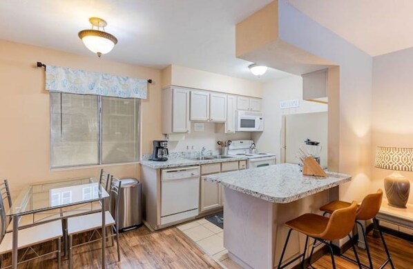 Enjoy cooking and dining in this well-equipped kitchen with a central island and adjacent dining area.