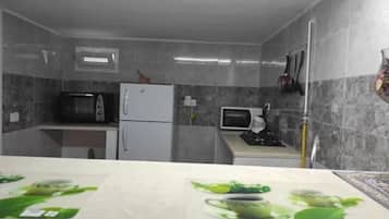 Fridge, stovetop, electric kettle, cookware/dishes/utensils