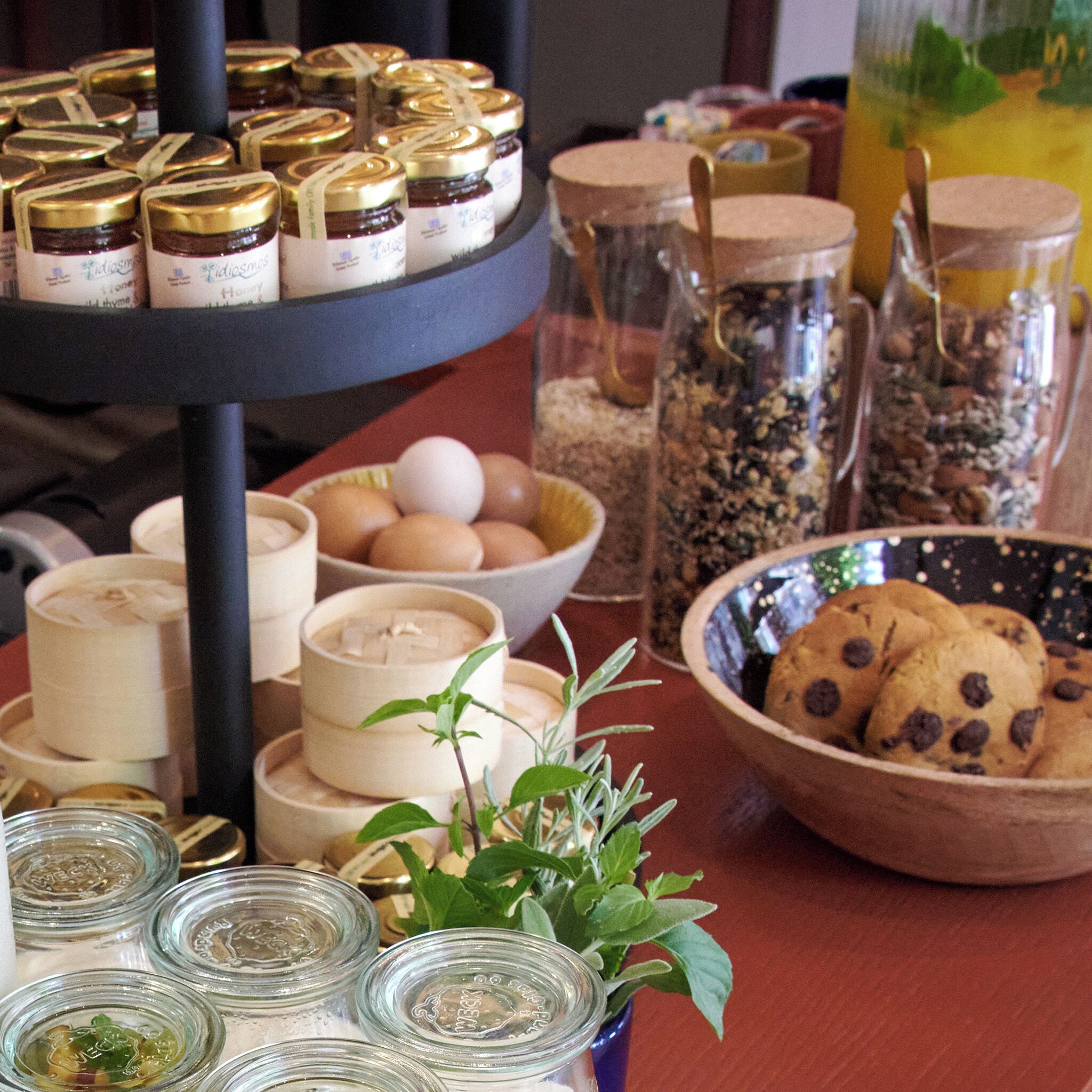 A display of various food items including jars of honey, cookies, and a bowl of eggs.