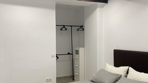 A bedroom with a bed, a wardrobe, and a built-in wardrobe with hanging space. - New apartment in the center silver ground floor 2 rooms (Elche)