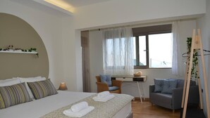 Ein modernes Schlafzimmer mit einem großen Bett, einem Schreibtisch und einem Stuhl.