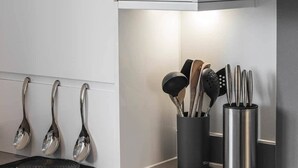 A modern kitchen with stainless steel appliances, a black induction cooktop, and a digital clock displaying 10:29. - Beach Mews | Central | Family house | Parking (Broadstairs)