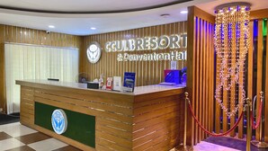 A hotel reception desk with a sign reading "CCULBRESORT & Convention Hall".