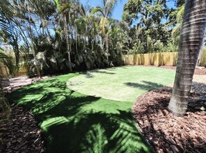 Enjoy a serene and outdoor space surrounded by lush greenery and tropical plants.