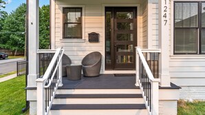 A house with a porch, two wicker chairs, a mailbox, and a door with a number 1247 on the wall. - The White House DC/Arlington (Arlington)