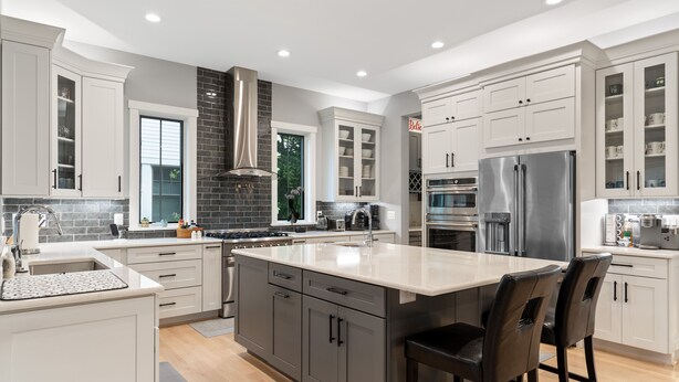A modern kitchen with a large island, stainless steel appliances, and white cabinetry. - The White House DC/Arlington (Arlington)