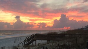 A wooden bench by the beach with a view of the ocean and a sunset. - Gorgeous 203C Gulf Shores Surf and Racket Club (Gulf Shores)