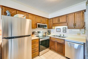 Enjoy cooking in this well-equipped kitchen with a refrigerator, microwave, oven, and dishwasher.