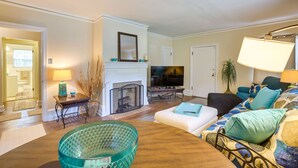 A living room with a fireplace, television, and comfortable seating. - Cozy Tuskegee Home - 20 Mi to Auburn University! (Tuskegee)