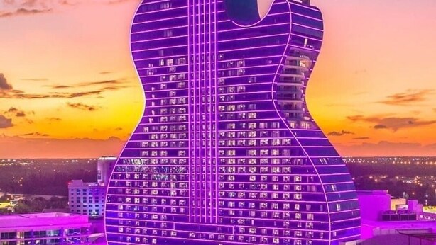 A building shaped like a guitar with multiple floors, surrounded by a resort area with pools and villas. - Blackrock Lux ~ High-End Designer Oasis ~ 7min from Airport ~ EV Charger (Fort Lauderdale)