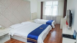 A hotel room with two beds, a TV, a desk, and a window with curtains. - Junyi · Leishen Jingjie E-Sports Hotel (Beijing Yanqing Global Xinyi Department Store) (Beijing)