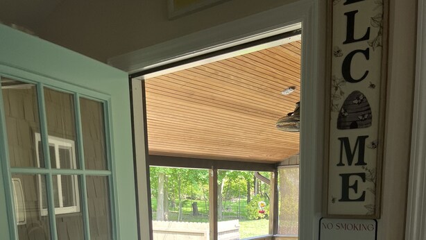 A wooden deck with a picnic table and a 'NO SMOKING' sign. - Cozy Country Cottage #2 (Miller Place)
