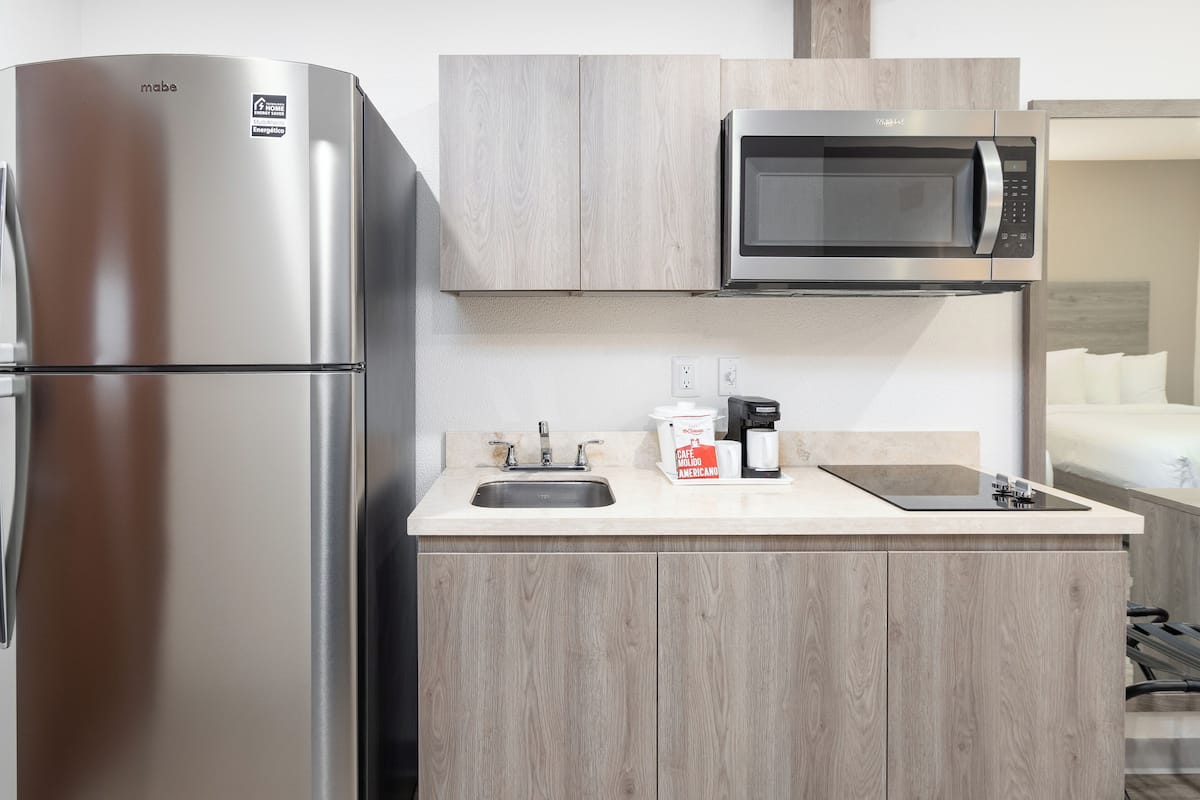 full-sized fridge, microwave, stovetop, cookware/dishes/utensils