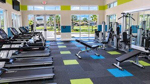 A gym with treadmills, a bench, and weight machines.