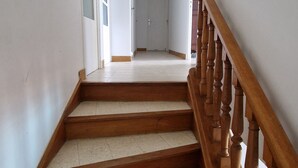 A staircase with wooden balusters leading to a landing.
