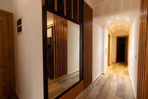 Comfort Apartment | Living room | 65-inch Smart TV with cable channels, TV - Oak Orchid Opulent 2 BR Apartment with Walk-in Closet (Cairo)