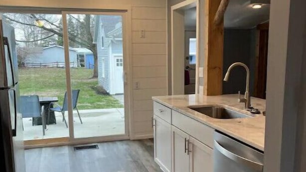 A modern kitchen with a sliding glass door leading to a patio area.
