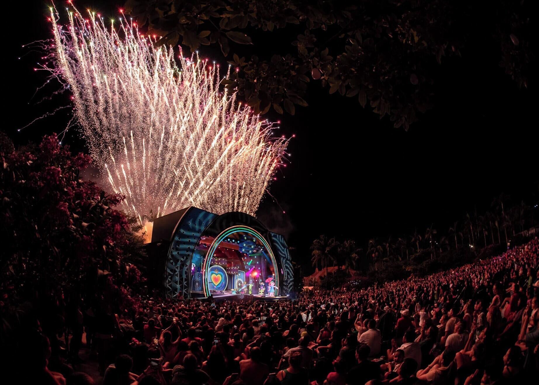 A concert stage with a crowd of people.