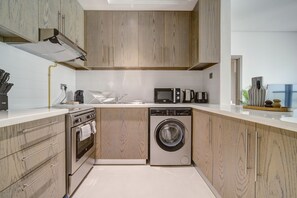 Fridge, microwave, oven, stovetop - Elegant 1BR at Montrose Residence B Al Barsha South by Deluxe Holiday Homes (Dubai)