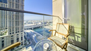 A balcony with a clear view of a cityscape, including a river and high-rise buildings.