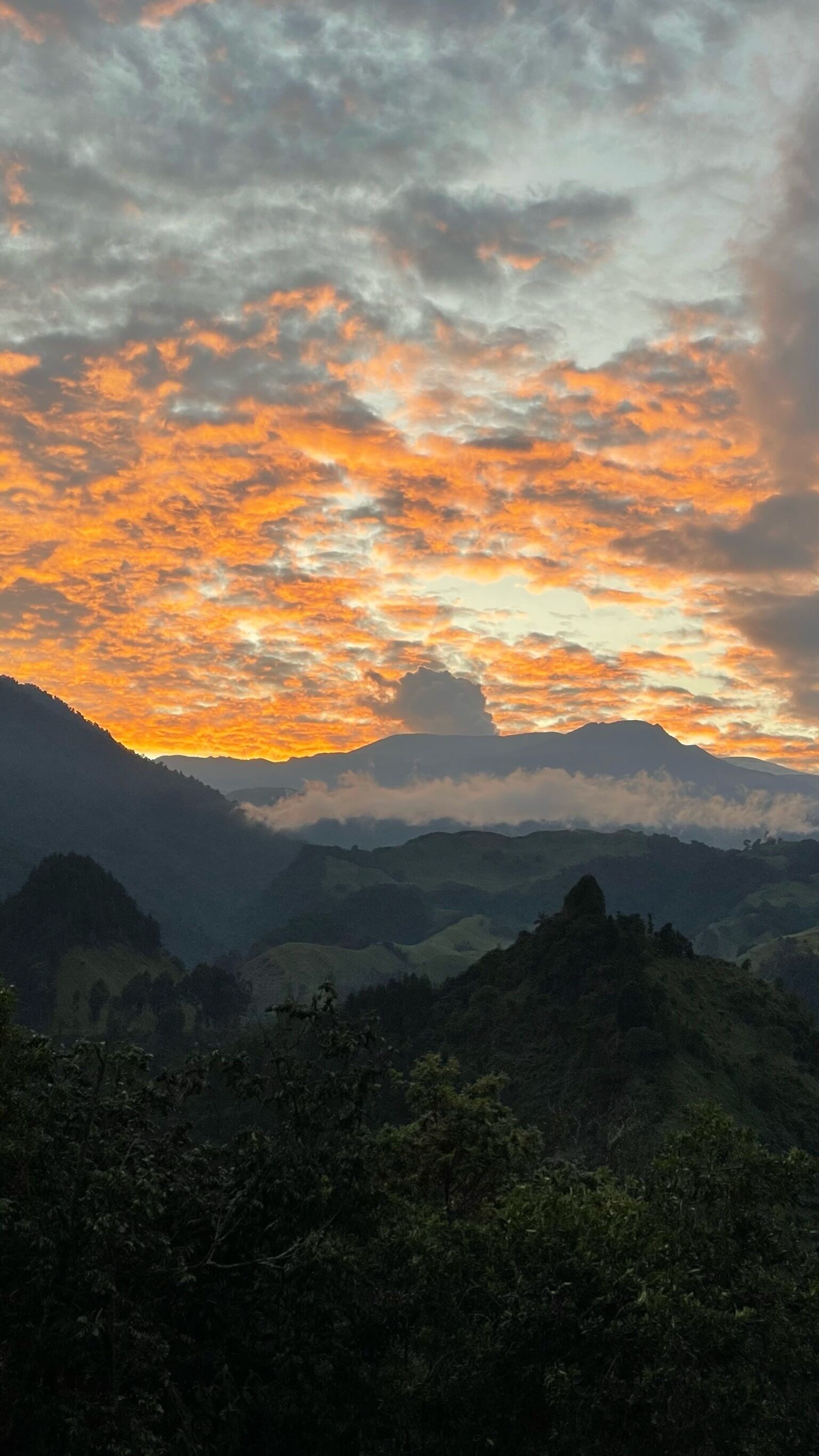 A mountainous landscape with a sunset.