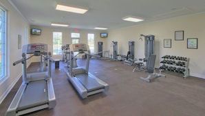 A gym with treadmills, weight machines, and dumbbells. - Three Bedroom, Luxury Condo, Hilton Head Island, SC 3348165 (Hilton Head Island)