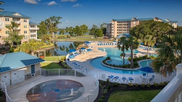 A resort with a large pool, lounge chairs, and a water feature. - Three Bedroom, Luxury Condo, Hilton Head Island, SC 3348165 (Hilton Head Island)