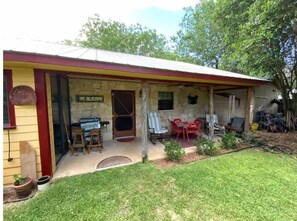 Enjoy outdoor dining or relaxation on the porch with a table and chairs.