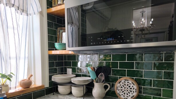A kitchen with a microwave, stove, and various kitchen utensils. - Historic Intimate Studio A (Haines City)