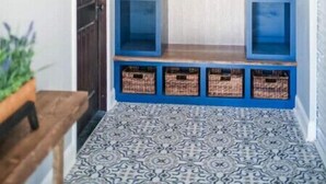 A hallway with a blue bench, baskets, and a sign. - Barndominium with Access to Horse Farm and Fishing (Comer)