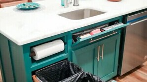 A compact kitchen with teal cabinetry, a white countertop, a stainless steel sink, and a trash bin. - Barndominium with Access to Horse Farm and Fishing (Comer)