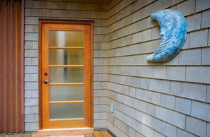 A wooden door with a glass panel and a metal handle.