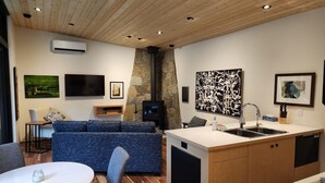 A modern kitchen with a built-in stove, a white countertop, and a sink. - Modern Forest Guest Suite - Accessible Seclusion! (Madeira Park)