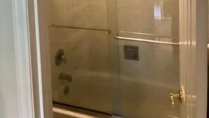 A bathroom with a glass shower enclosure, a visible showerhead, and a tiled wall. - #108 Condo near large pool & shuttle to Gorge Amp-book separately (Quincy)