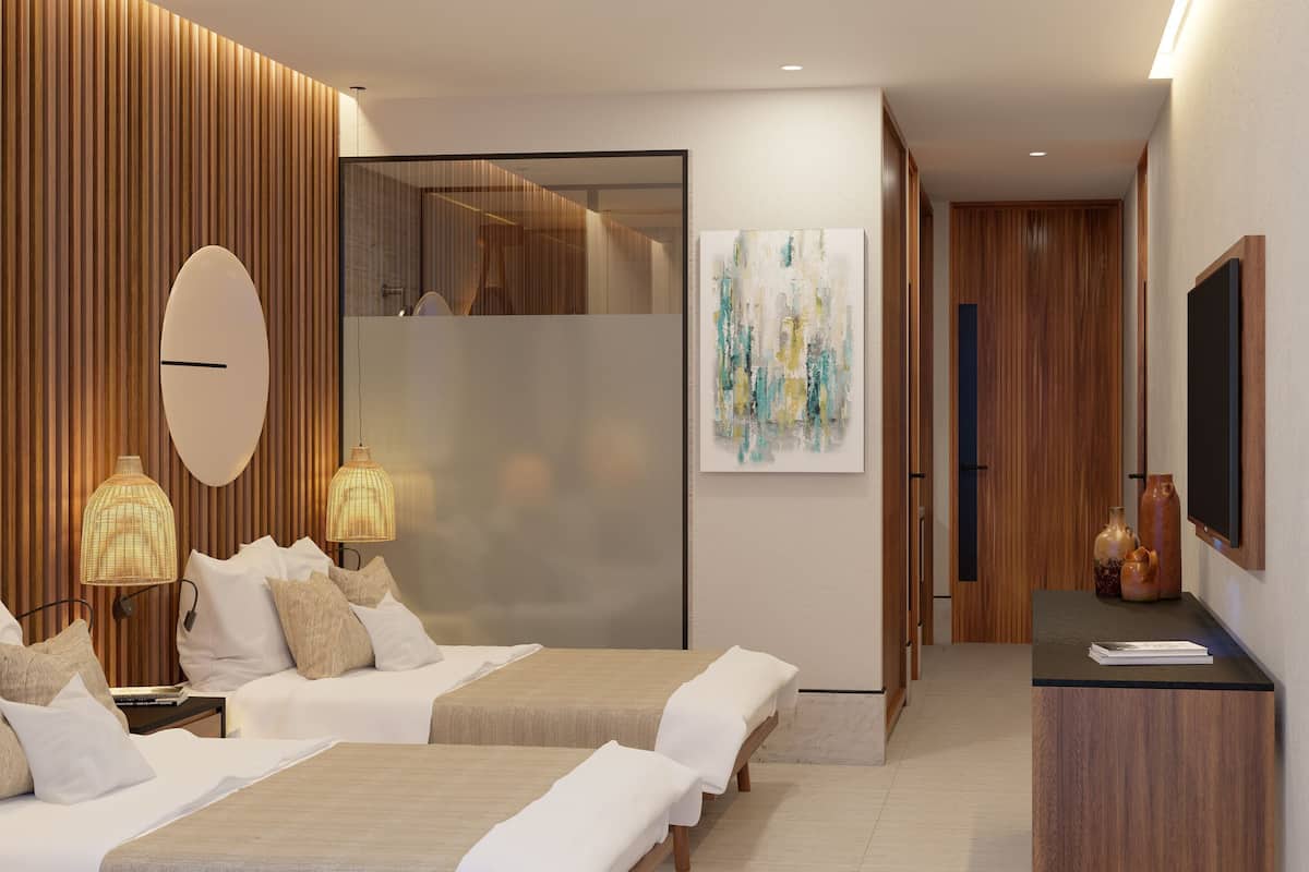A modern hotel room with a large bed, bedside lamps, a flat-screen TV, and a painting on the wall.