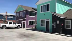 A row of colorful townhouses with a white truck parked in front. - One Bedroom Hideaway (Reno)