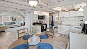 A spacious loft-style living area with a kitchen and dining space.