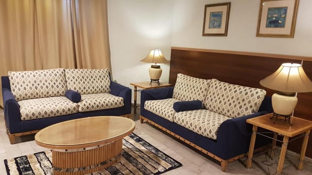 A living room with two sofas, a coffee table, and two lamps.