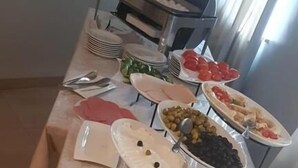 A buffet table with various food items including meats, cheeses, and pastries. - Concord hotel  (Amman)