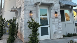 A two-story stone building with a white door, windows, and a small porch area. - The Silo Inn near Zion, Snow Canyon and Bryce Canyon! honeymoon getaway. 2023 (Washington)