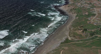 The ocean meets the meadow at the forest's edge. Private beach. Soak under stars