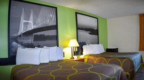 Relax in a stylish room with a large bed, nightstand, and wall-mounted picture.