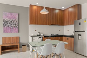 Fridge, electric kettle, dining tables