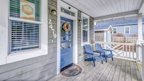 A wooden porch with a blue door, two blue Adirondack chairs, and a decorative wreath. - Relax and Refresh, Seconds From Beach, Bedrooms w/ En-Suite Bathrooms, Community Pool, Fire-Pit, BBQ (Lincoln City)