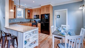 A modern kitchen with granite countertops, wooden cabinets, and stainless steel appliances. - Relax and Refresh, Seconds From Beach, Bedrooms w/ En-Suite Bathrooms, Community Pool, Fire-Pit, BBQ (Lincoln City)