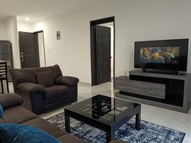 Superior Suite | Living area | 50-inch Smart TV with satellite channels, Netflix, streaming services