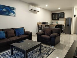 Superior Suite | Living area | 50-inch Smart TV with satellite channels, Netflix, streaming services