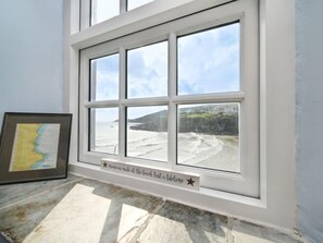 Enjoy breathtaking views of the beach and cliffs from this room's large window.